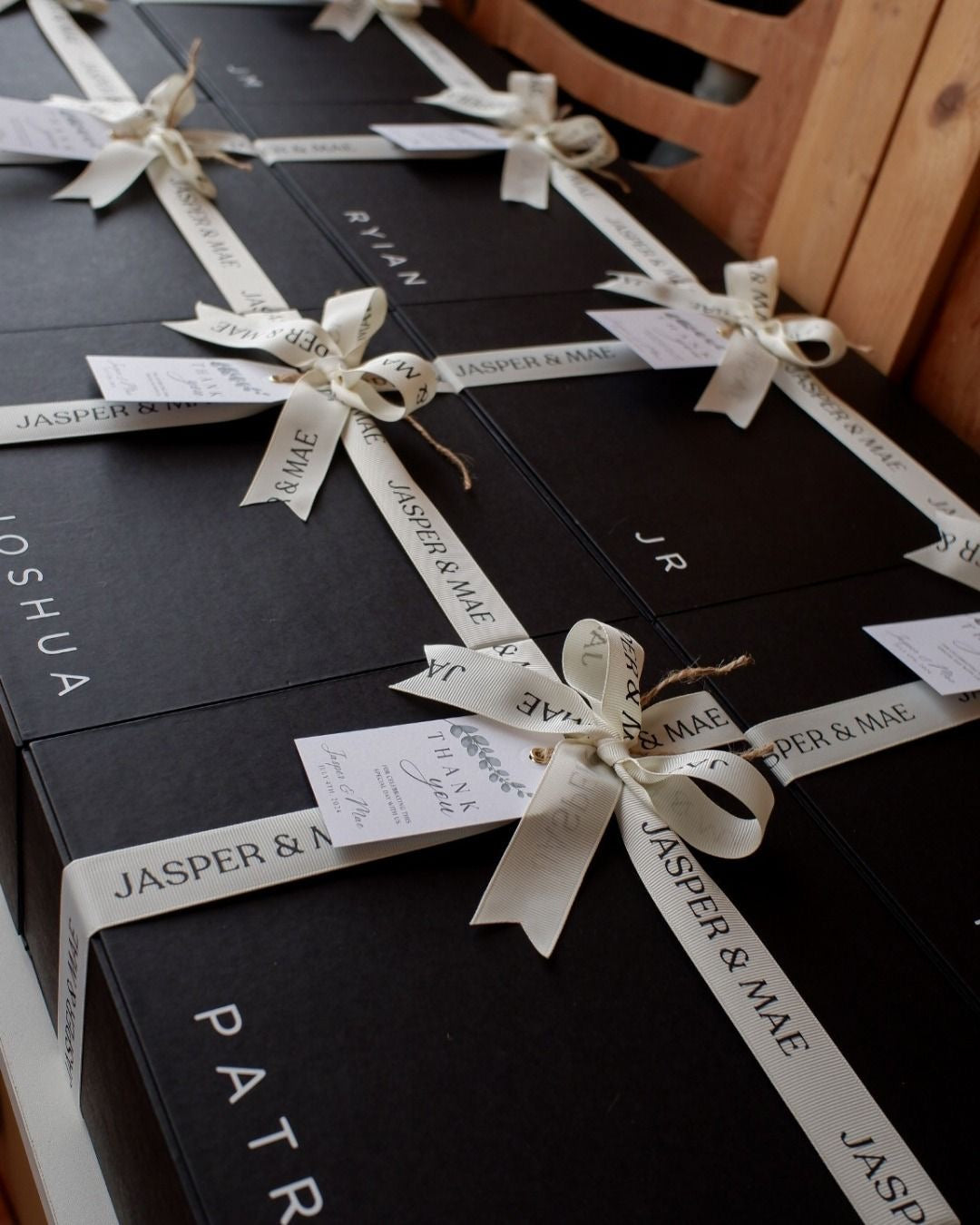 Satin ribbon wrapped around black gift boxes
